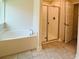 Bathroom featuring tub, separate glass shower, and tile floor at 4326 Sagefield Dr, Harmony, FL 34773