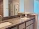 Double sinks are featured in this bathroom with granite countertops, plus stylish cabinetry and fixtures at 4326 Sagefield Dr, Harmony, FL 34773