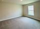 Cozy carpeted bedroom with a bright window and electrical outlets on the walls at 4326 Sagefield Dr, Harmony, FL 34773