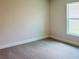 Cozy carpeted bedroom with a bright window and electrical outlets on the walls at 4326 Sagefield Dr, Harmony, FL 34773
