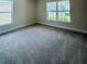 A carpeted bedroom with large windows that offer plenty of natural light at 4326 Sagefield Dr, Harmony, FL 34773