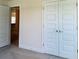 Bright bedroom featuring neutral walls, carpet, and a closet with double doors at 4326 Sagefield Dr, Harmony, FL 34773