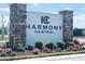 A view of the entrance sign for Harmony Central community with colorful landscaping at 4326 Sagefield Dr, Harmony, FL 34773
