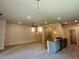 Open floor plan featuring a kitchen island with seating open to the dining and living rooms at 4326 Sagefield Dr, Harmony, FL 34773