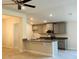 Well-lit kitchen with granite countertops, gray cabinets and stainless steel appliances at 4326 Sagefield Dr, Harmony, FL 34773