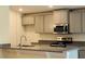 Beautiful kitchen featuring granite countertops, gray cabinets and stainless steel microwave at 4326 Sagefield Dr, Harmony, FL 34773