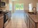 Well-lit kitchen with stainless steel appliances and granite countertops at 4326 Sagefield Dr, Harmony, FL 34773