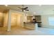 Open floor plan featuring the kitchen, living and dining areas under a ceiling fan at 4326 Sagefield Dr, Harmony, FL 34773