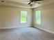 The main bedroom features neutral carpet, two large windows, and a ceiling fan at 4326 Sagefield Dr, Harmony, FL 34773