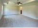 Spacious primary bedroom featuring a modern ceiling fan and bright windows at 4326 Sagefield Dr, Harmony, FL 34773