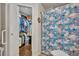 Bathroom with a walk-in closet, stylish vanity, and flamingo print shower curtain at 4740 Walden Cir # 28, Orlando, FL 32811