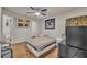 Neutral toned bedroom with wood flooring and a view into the ensuite bathroom at 4740 Walden Cir # 28, Orlando, FL 32811