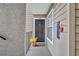 Charming front door with a welcome mat, enhanced by a decorative flower pot and patriotic decor at 4740 Walden Cir # 28, Orlando, FL 32811