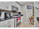Kitchen featuring stainless steel appliances, white cabinets, and black granite countertops at 4740 Walden Cir # 28, Orlando, FL 32811