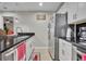 Kitchen featuring sleek black countertops, white cabinets, and modern stainless steel appliances at 4740 Walden Cir # 28, Orlando, FL 32811