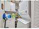 Laundry room featuring stacked washer and dryer units and white cabinets for storage at 4740 Walden Cir # 28, Orlando, FL 32811
