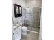 Bathroom with granite countertop sink and shower with sliding glass door at 5107 Appenine W Loop, St Cloud, FL 34771