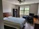 Bedroom with a bed, a desk, and a window at 5107 Appenine W Loop, St Cloud, FL 34771