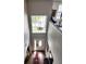 Bright foyer showcasing a high ceiling, front door with a large window, and hardwood flooring at 5107 Appenine W Loop, St Cloud, FL 34771