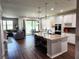 Open-concept kitchen with a large island, connecting to the living room and dining area at 5107 Appenine W Loop, St Cloud, FL 34771