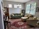Cozy living room featuring hardwood floors and plenty of natural light from a large window at 5107 Appenine W Loop, St Cloud, FL 34771