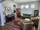 Cozy living room featuring hardwood floors, piano, and lots of natural light at 5107 Appenine W Loop, St Cloud, FL 34771