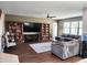 Spacious living room boasts hardwood floors, large TV, ceiling fan, and comfortable gray sectional at 5107 Appenine W Loop, St Cloud, FL 34771