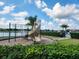Community playground featuring a slide, monkey bars, and lush greenery with a scenic pond view at 5107 Appenine W Loop, St Cloud, FL 34771