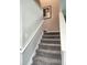 Carpeted staircase with white railing leading to the upper level of the home at 5107 Appenine W Loop, St Cloud, FL 34771