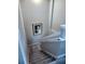 Carpeted staircase with white railing leading to the lower level of the home at 5107 Appenine W Loop, St Cloud, FL 34771