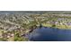 Aerial view of a community with a pool, lake, and houses, showcasing the desirable amenities and waterfront living at 5365 Bowman Dr, Winter Garden, FL 34787