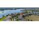 Aerial view showcases a beautiful lakeside home, surrounded by mature trees and manicured lawns at 5365 Bowman Dr, Winter Garden, FL 34787