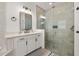 Bright bathroom featuring a modern shower, sleek vanity and tile at 5365 Bowman Dr, Winter Garden, FL 34787