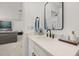 Modern powder room features a white vanity, sleek black hardware, and designer mirror at 5365 Bowman Dr, Winter Garden, FL 34787