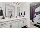 Modern bathroom with dual vanities, black hardware, and a Stormtrooper themed shower curtain at 5365 Bowman Dr, Winter Garden, FL 34787