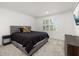 Cozy bedroom with neutral tones, features plantation shutters, plush carpet, and a comfortable bed at 5365 Bowman Dr, Winter Garden, FL 34787