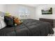 Bright bedroom features a large window, a dark wood dresser, and a bed with decorative stuffed animals at 5365 Bowman Dr, Winter Garden, FL 34787