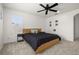Bright bedroom features a ceiling fan, a large window, and a comfortable bed at 5365 Bowman Dr, Winter Garden, FL 34787