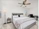 Bright bedroom with plush carpet features a ceiling fan, desk and work space, and comfortable bed at 5365 Bowman Dr, Winter Garden, FL 34787