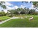 Well-maintained community park features a curved seating area and a walking path, ideal for relaxation and outdoor activities at 5365 Bowman Dr, Winter Garden, FL 34787