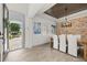 Bright dining room with wood floors, stone accent wall, and an open view to the home's entry at 5365 Bowman Dr, Winter Garden, FL 34787