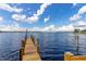 Dock in the lake. A beautiful lake view with blue skies and fluffy clouds overhead at 5365 Bowman Dr, Winter Garden, FL 34787