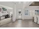 Bright foyer featuring wood floors, an elegant front door, and an open view of the dining and living areas at 5365 Bowman Dr, Winter Garden, FL 34787