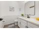 Bright half bathroom with white vanity, modern fixtures, and stylish coastal decor at 5365 Bowman Dr, Winter Garden, FL 34787