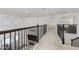 Bright and airy hallway with neutral decor, modern railing, and views into the living spaces at 5365 Bowman Dr, Winter Garden, FL 34787