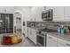 Chef's kitchen with granite counters, stainless steel appliances, and designer tile backsplash at 5365 Bowman Dr, Winter Garden, FL 34787