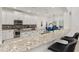 Modern kitchen features sleek countertops, island, stainless steel appliances, and bar stool seating at 5365 Bowman Dr, Winter Garden, FL 34787