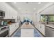 Well-lit kitchen features granite countertops, stainless steel appliances, a center island and tile floors at 5365 Bowman Dr, Winter Garden, FL 34787