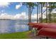 Lake view of boats, trees, and blue skies with fluffy clouds overhead at 5365 Bowman Dr, Winter Garden, FL 34787