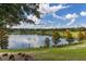Beautiful view of a tranquil lake surrounded by lush greenery and trees, enhancing the property's serene and natural appeal at 5365 Bowman Dr, Winter Garden, FL 34787